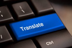 Blue translate button on a black keyboard