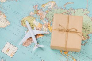 World map, model plane and a small box