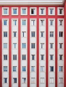 A building painted red and white with a lot of small windows