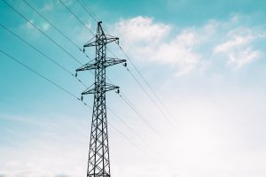 Electrical wires and a bright sky in the background